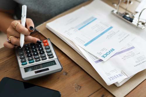 Accountant using a calculator for financial statements
